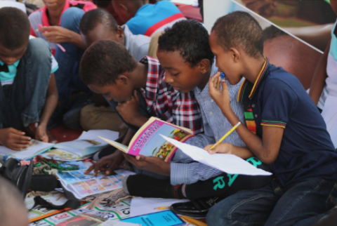 Children engaged in reading books together